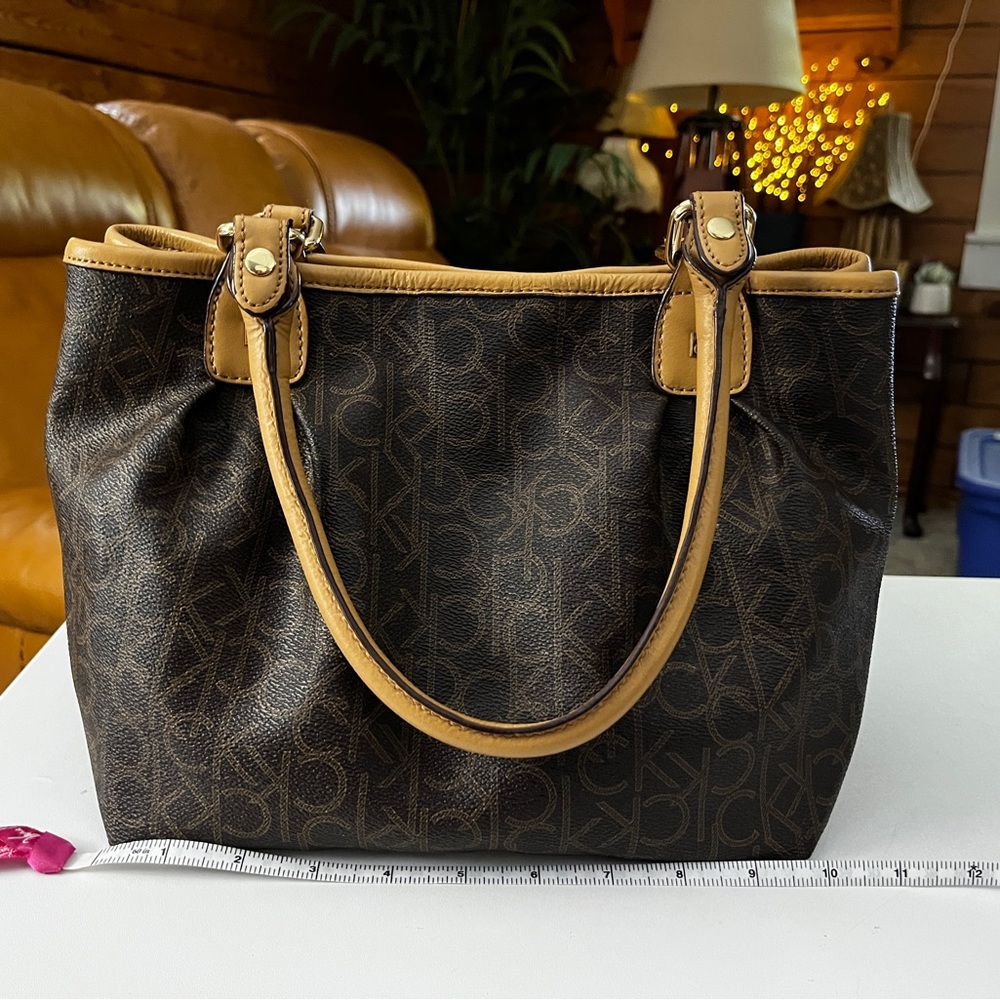 Calvin Klein Dark Brown Logo Satchel with Tan Trim 10” x 9” x 7”.